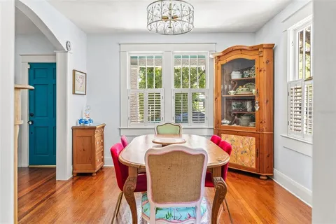 a dining room with furniture and a window
