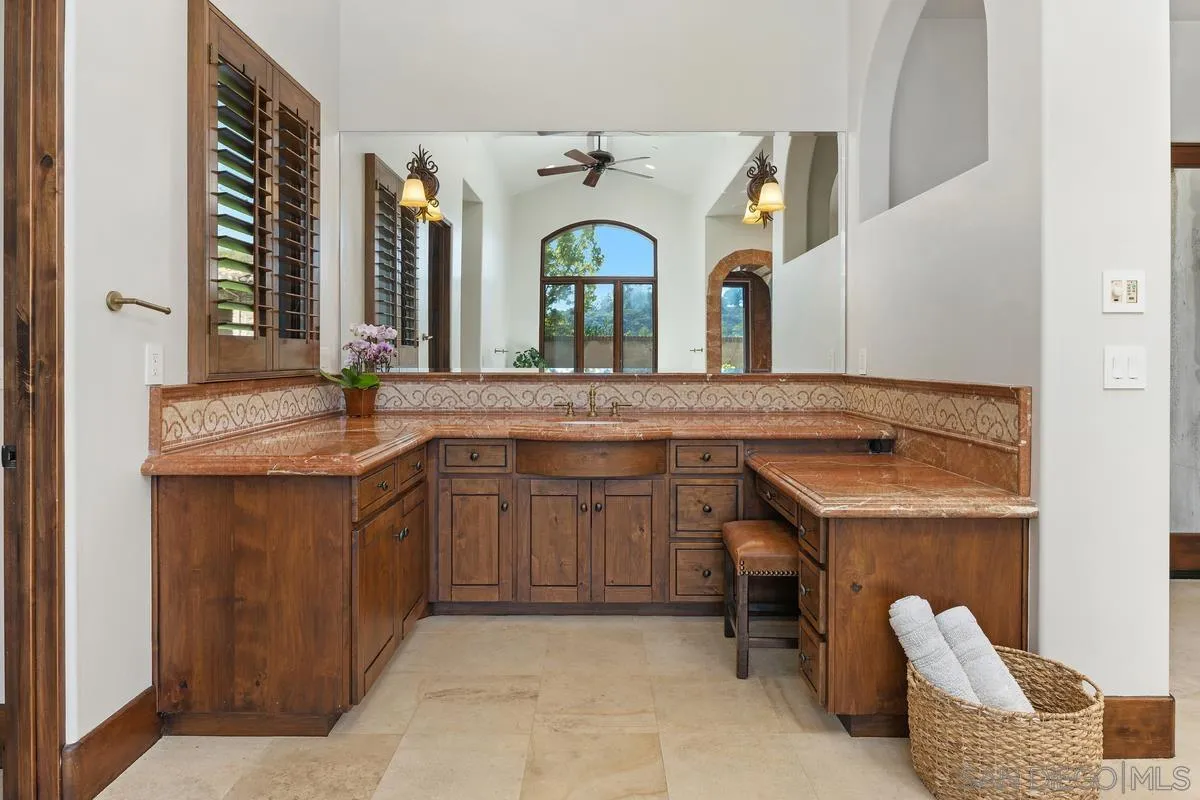 14778 El Rodeo Court Rancho Santa Fe, CA 92067 - Photo 13 of 29 a bathroom with a granite countertop sink and a mirror