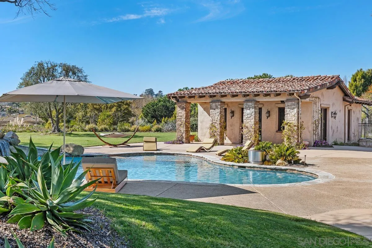 14778 El Rodeo Court Rancho Santa Fe, CA 92067 - Photo 18 of 29 a view of a house with swimming pool and sitting area