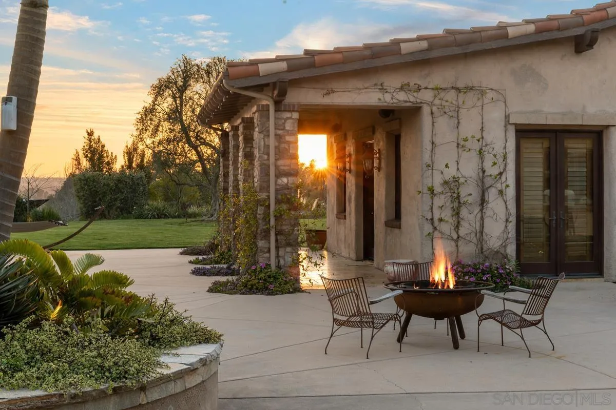 14778 El Rodeo Court Rancho Santa Fe, CA 92067 - Photo 24 of 29 a view of a patio with table and chairs with wooden floor and fence