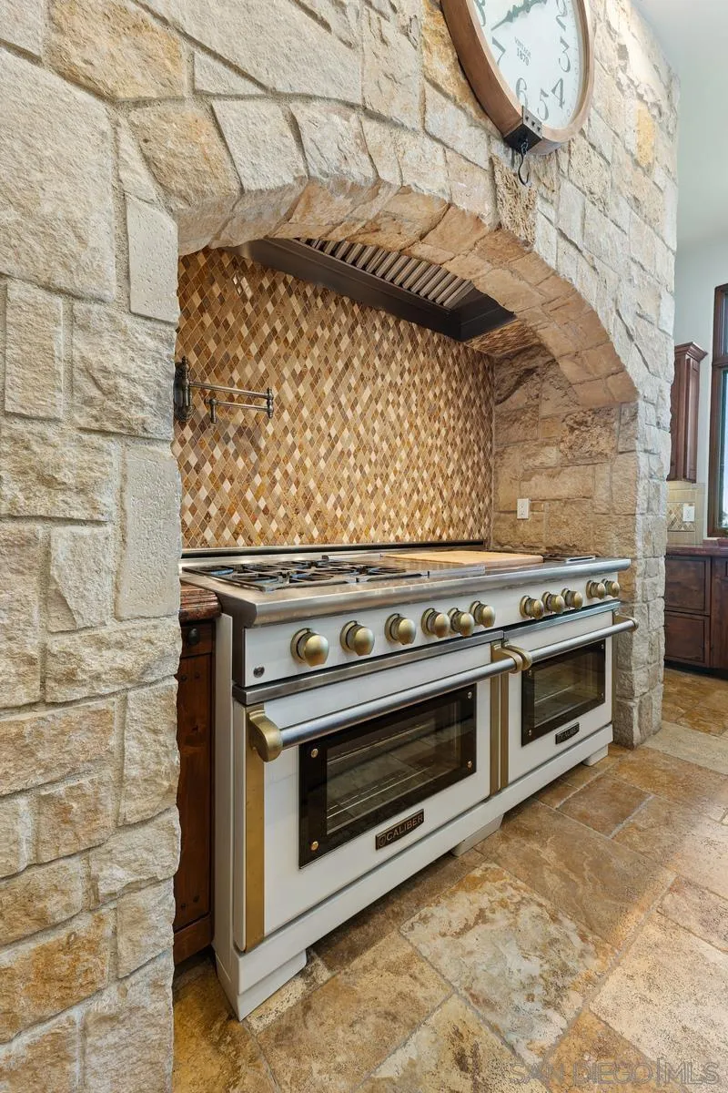 14778 El Rodeo Court Rancho Santa Fe, CA 92067 - Photo 6 of 29 a stove top oven sitting inside of a kitchen