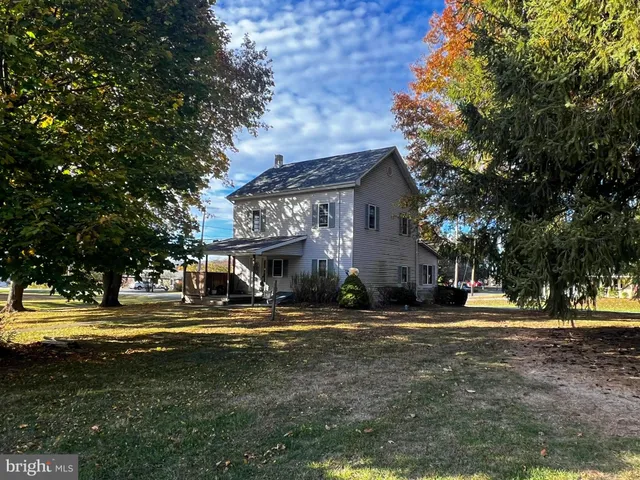 a front view of a building with trees