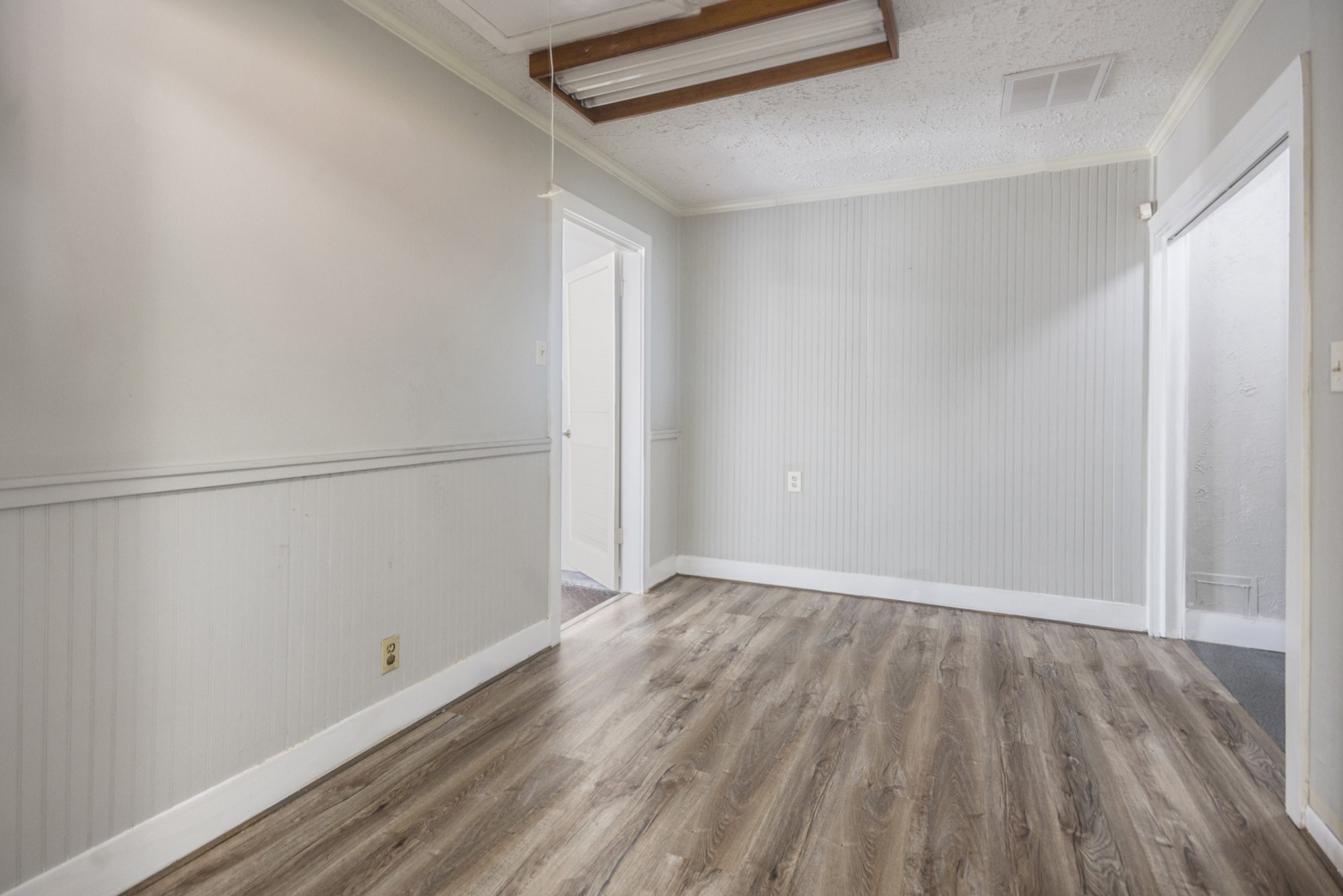 10619 Wheaton Drive Houston, TX 77089 - Photo 10 of 25 This bright room features elegant wood flooring and neutral walls, offering a versatile space perfect for personalization. Ideal for a cozy office or serene reading nook.