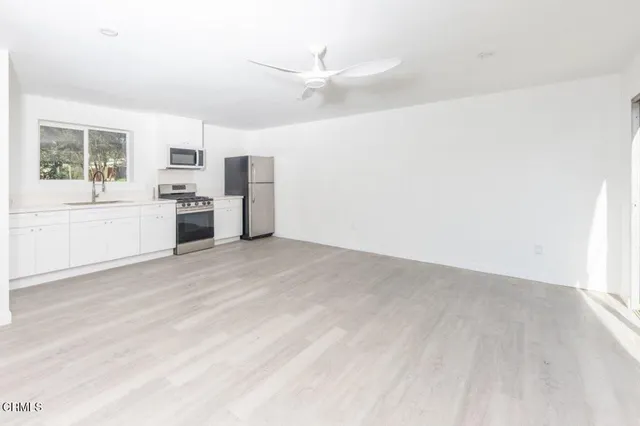 a view of a kitchen with a sink and a stove top oven