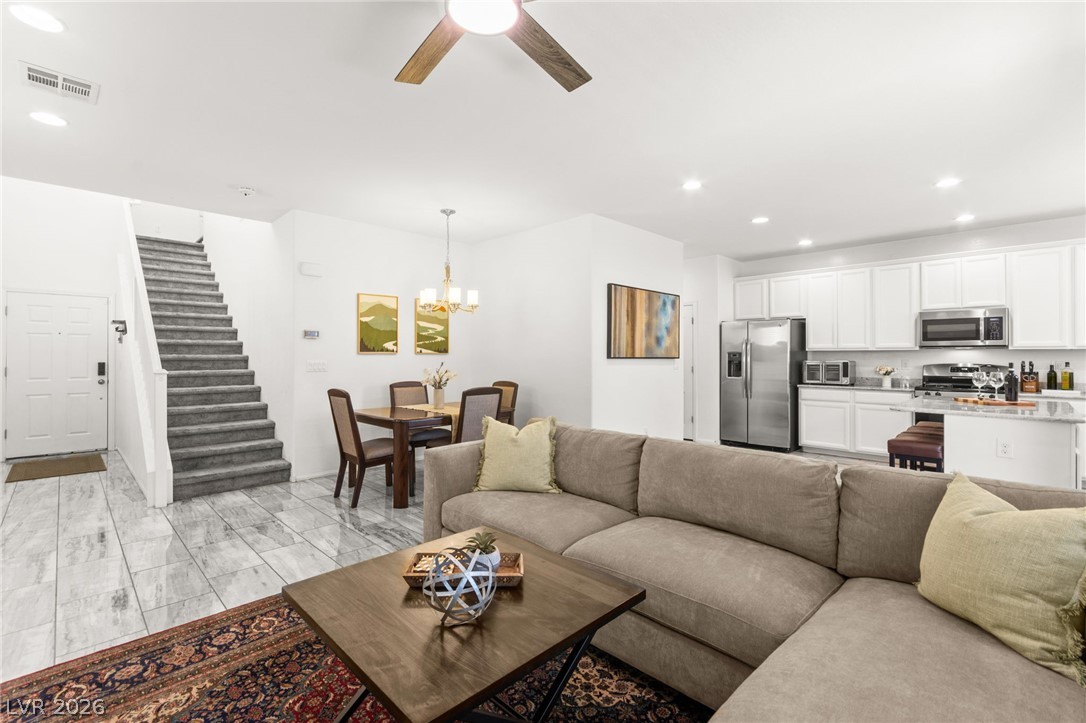 6435 Point Isabel Way Las Vegas, NV 89122 - Photo 10 of 57 An inviting open-concept layout seamlessly integrates living, dining, and kitchen areas.