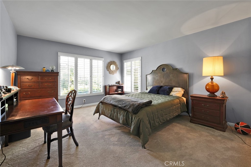 705 Chaucer Road San Marino, CA 91108 - Photo 22 of 35 a bedroom with a bed and a dresser next to a window