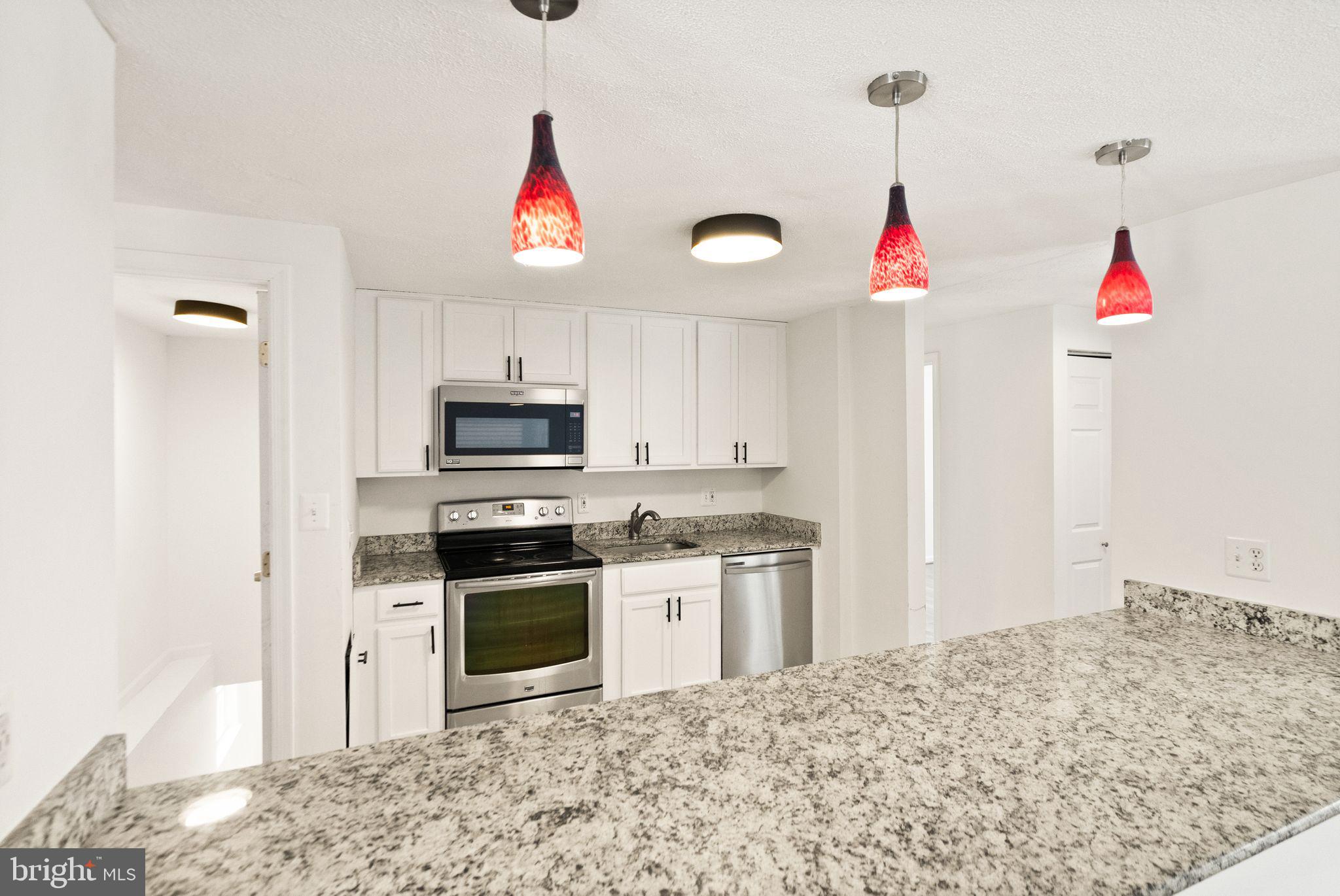 2280 Cocquina Drive Reston, VA 20191 - Photo 20 of 66 a kitchen with granite countertop a sink and a stove