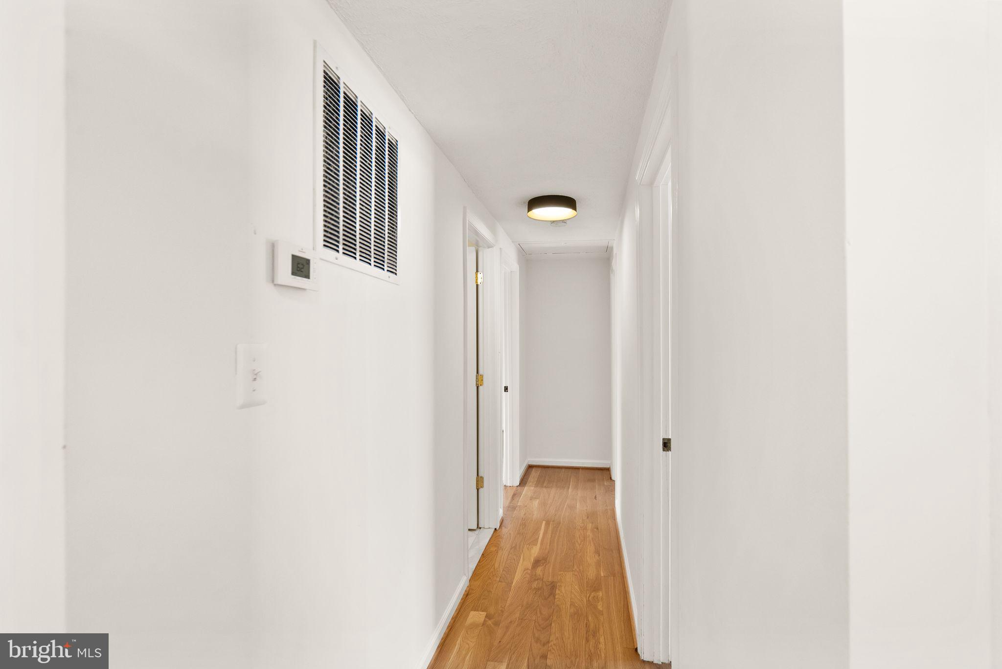 2280 Cocquina Drive Reston, VA 20191 - Photo 23 of 66 a view of a hallway with wooden floor