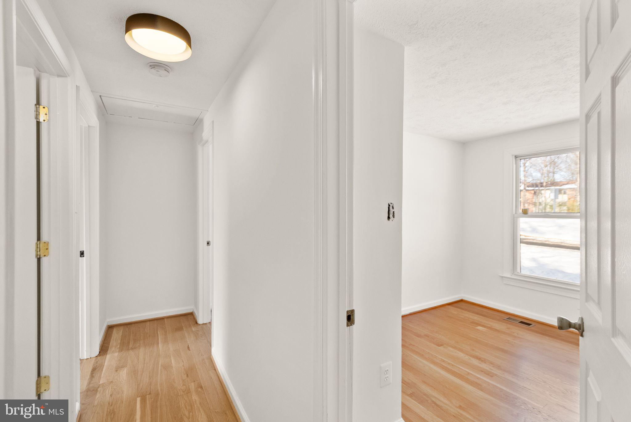 2280 Cocquina Drive Reston, VA 20191 - Photo 24 of 66 a view of hallway with wooden floor and fan