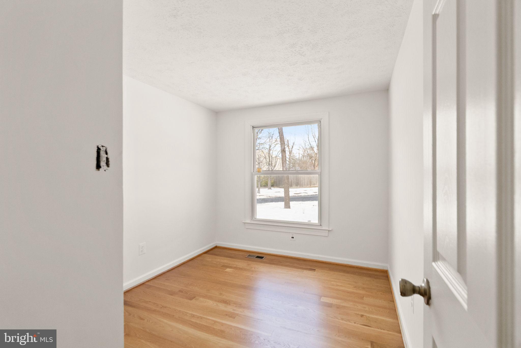 2280 Cocquina Drive Reston, VA 20191 - Photo 25 of 66 an empty room with wooden floor and windows