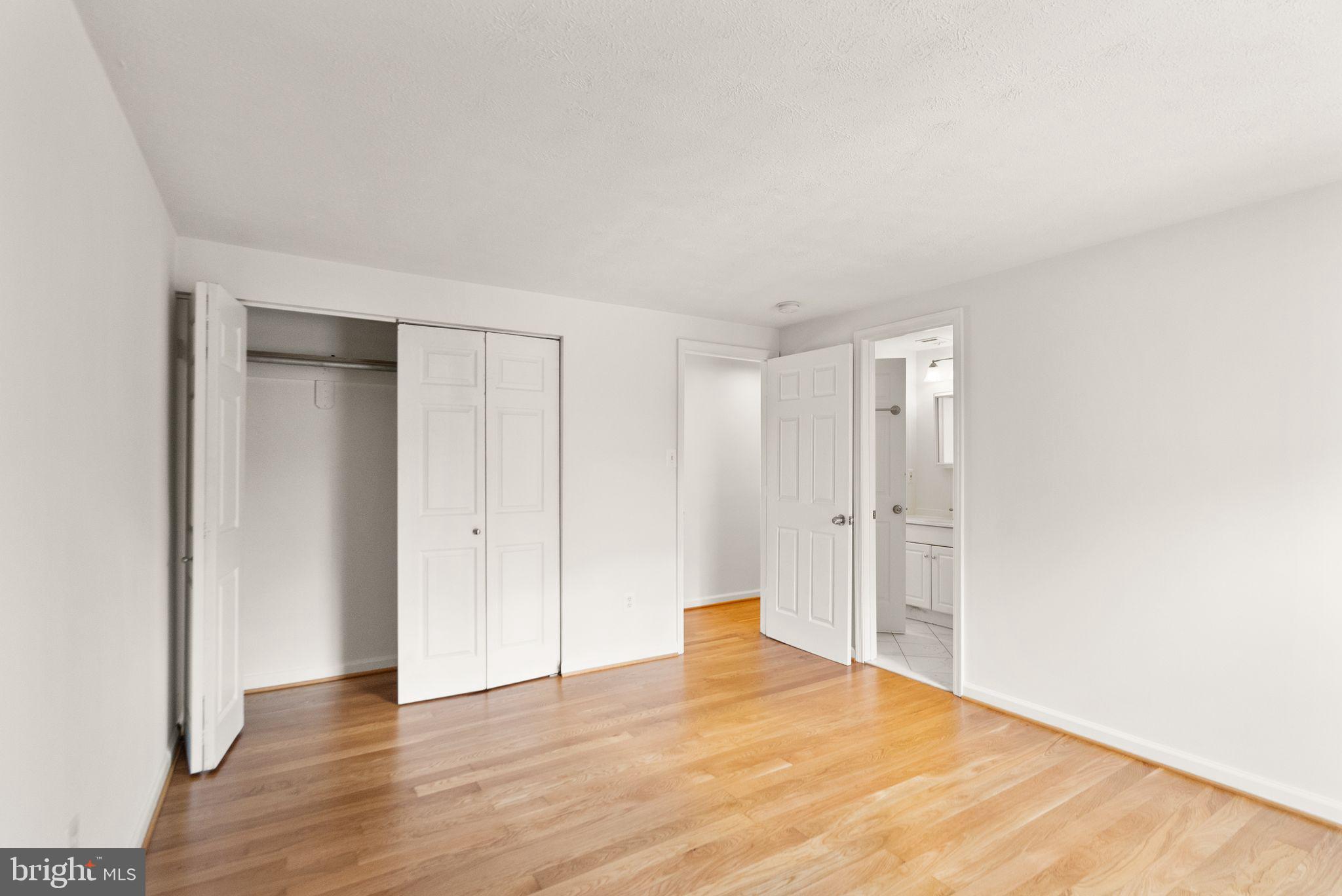 2280 Cocquina Drive Reston, VA 20191 - Photo 32 of 66 a view of an empty room with wooden floor and closet