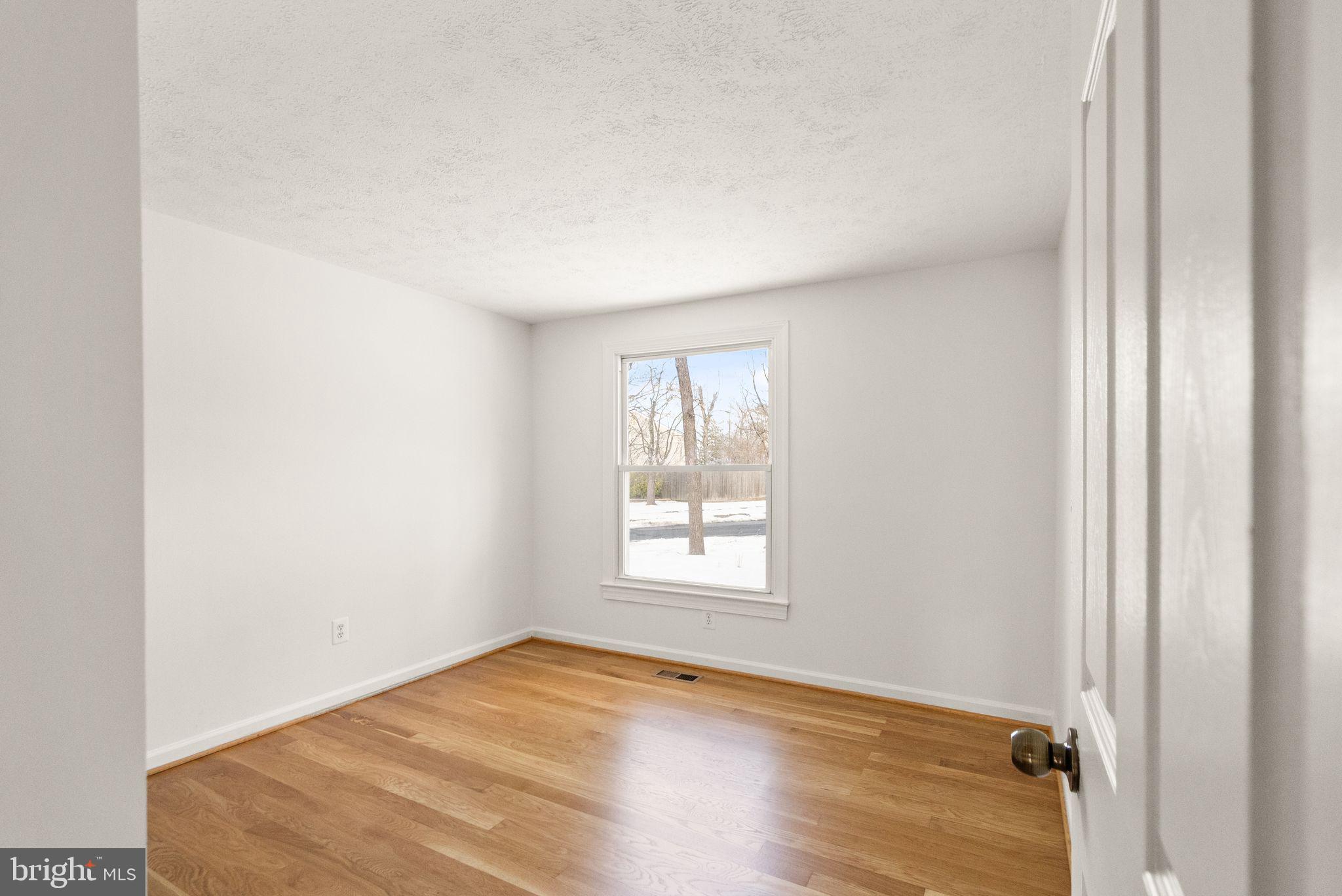 2280 Cocquina Drive Reston, VA 20191 - Photo 36 of 66 an empty room with wooden floor and windows