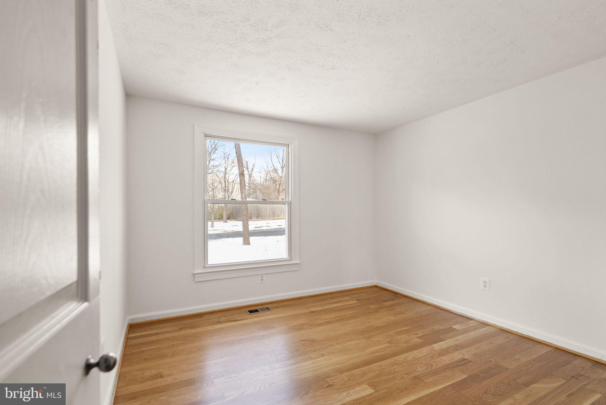 2280 Cocquina Drive Reston, VA 20191 - Photo 39 of 66 an empty room with wooden floor and windows
