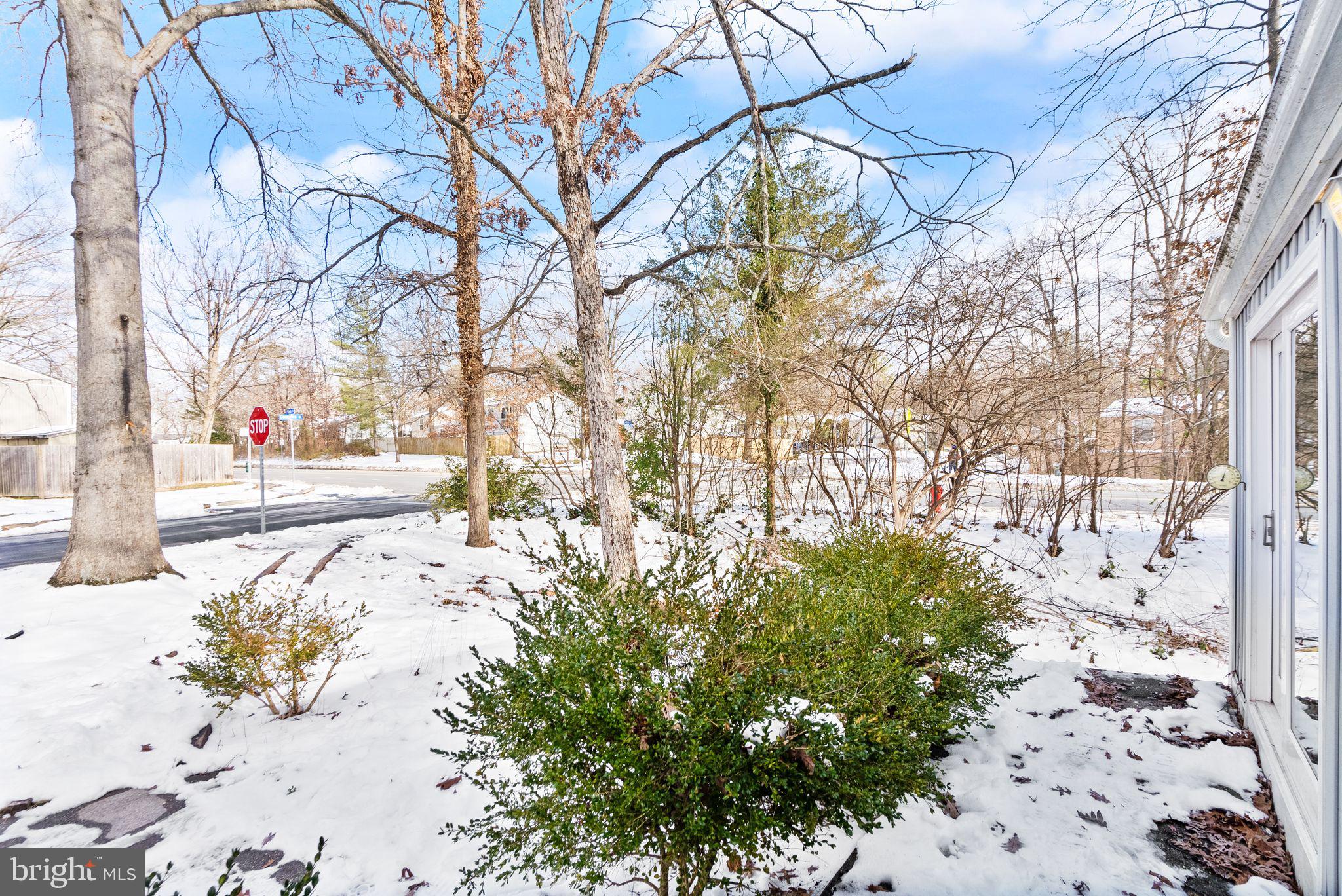 2280 Cocquina Drive Reston, VA 20191 - Photo 4 of 66 a view of a yard covered with snow in the front