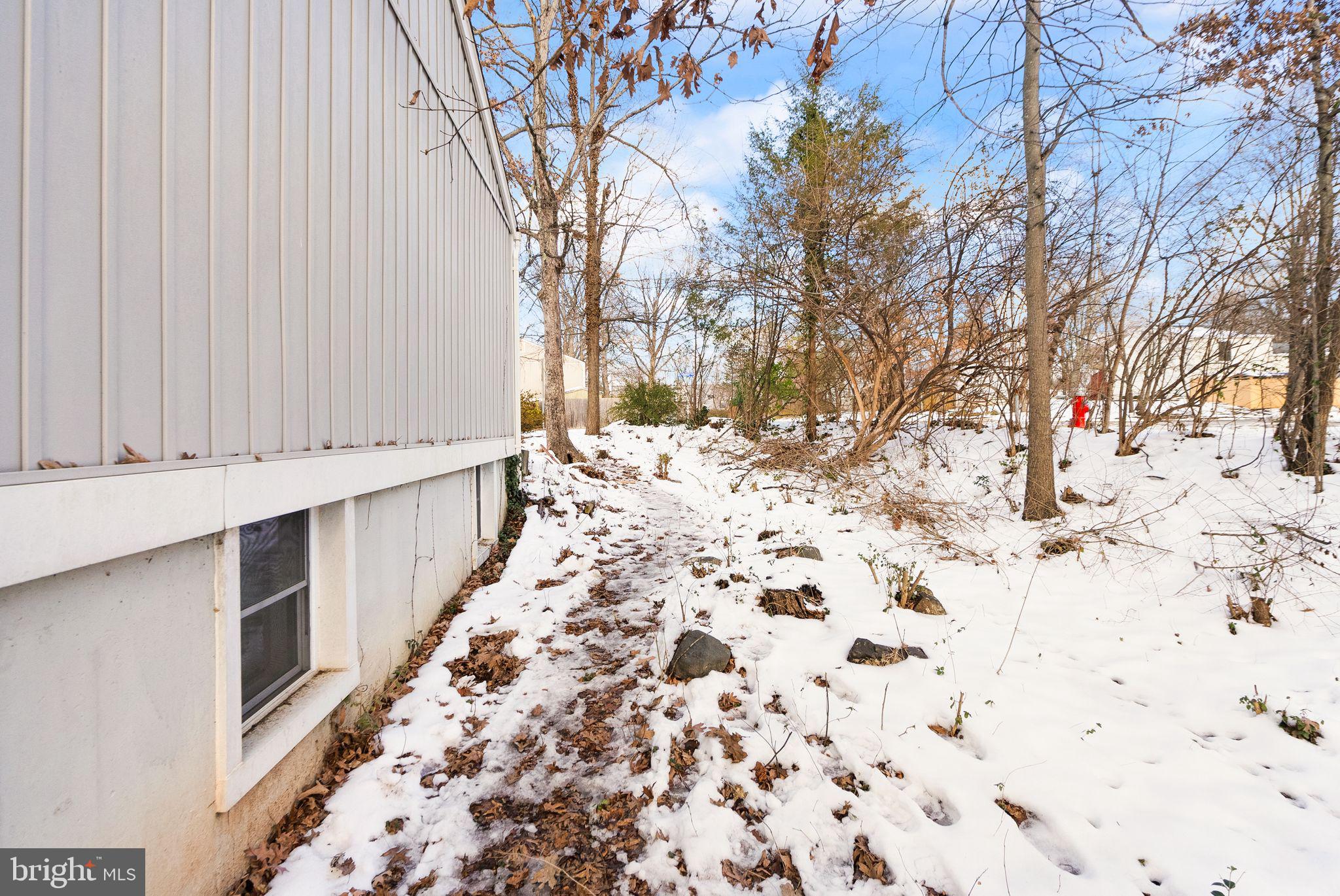 2280 Cocquina Drive Reston, VA 20191 - Photo 62 of 66 a view of a pathway covered with snow in front of door