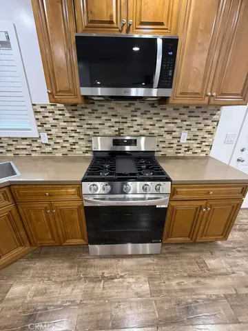 a stove top oven sitting inside of a kitchen