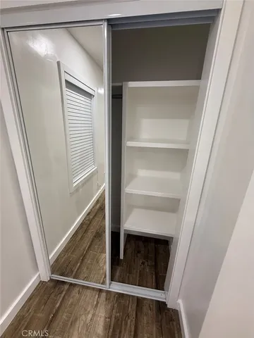 a view of walk in closet with empty racks