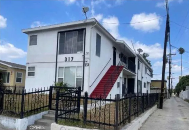 a front view of a house with wooden fence