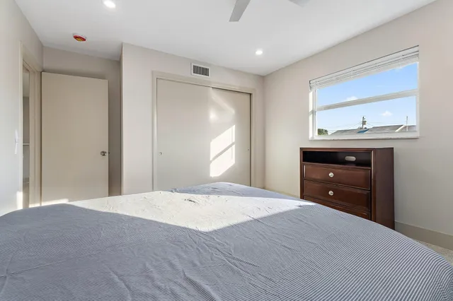 a bedroom with a bed and a dresser