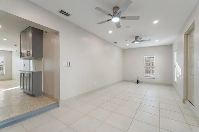 a view of an empty room with a kitchen