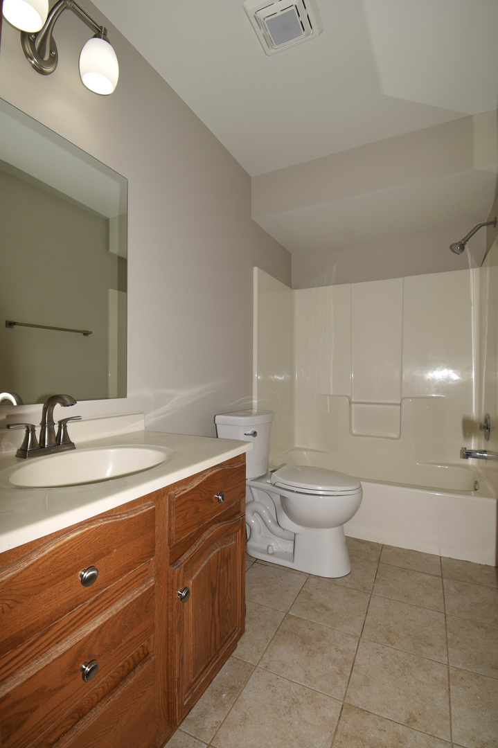 406 Garfield Road Fox Lake, IL 60041 - Photo 18 of 33 a bathroom with a toilet a sink and mirror