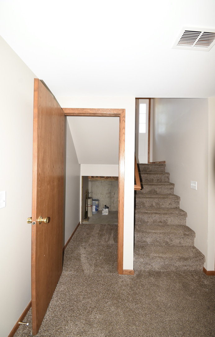 406 Garfield Road Fox Lake, IL 60041 - Photo 19 of 33 a view of a hallway with wooden shelves