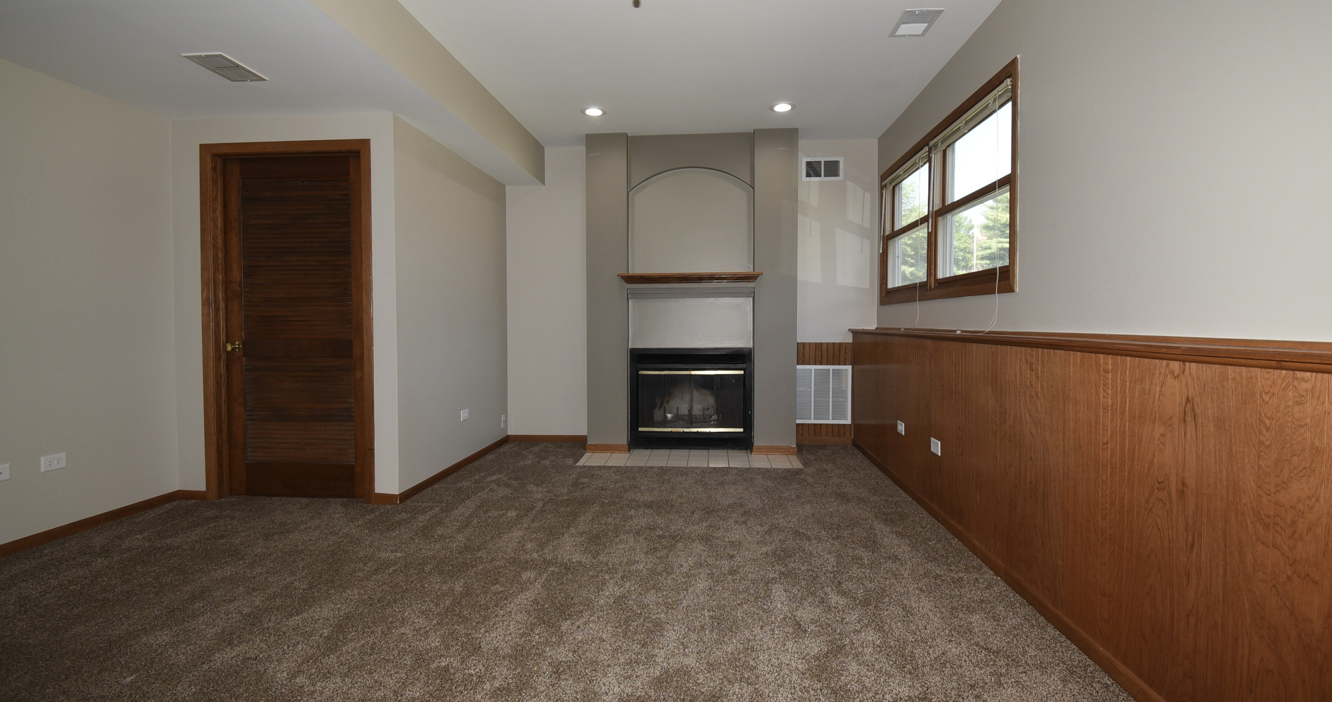 406 Garfield Road Fox Lake, IL 60041 - Photo 21 of 33 an empty room with a fireplace and a window