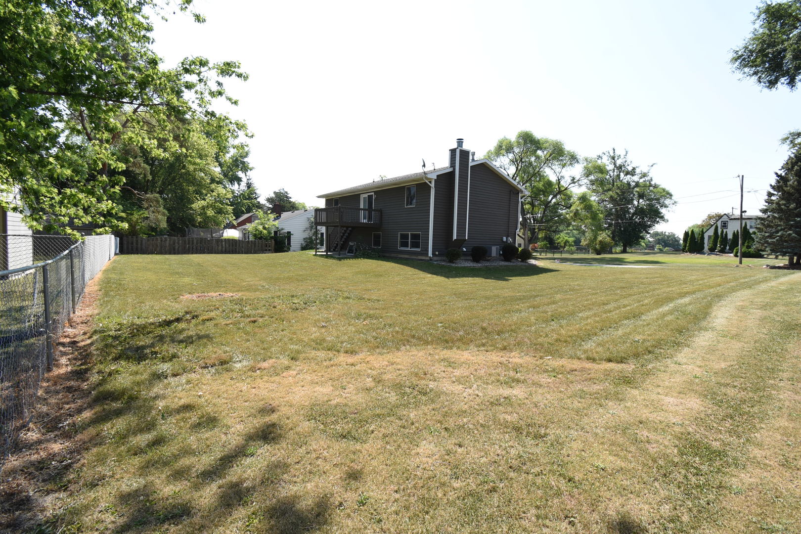 406 Garfield Road Fox Lake, IL 60041 - Photo 29 of 33 a big yard with trees in front of it