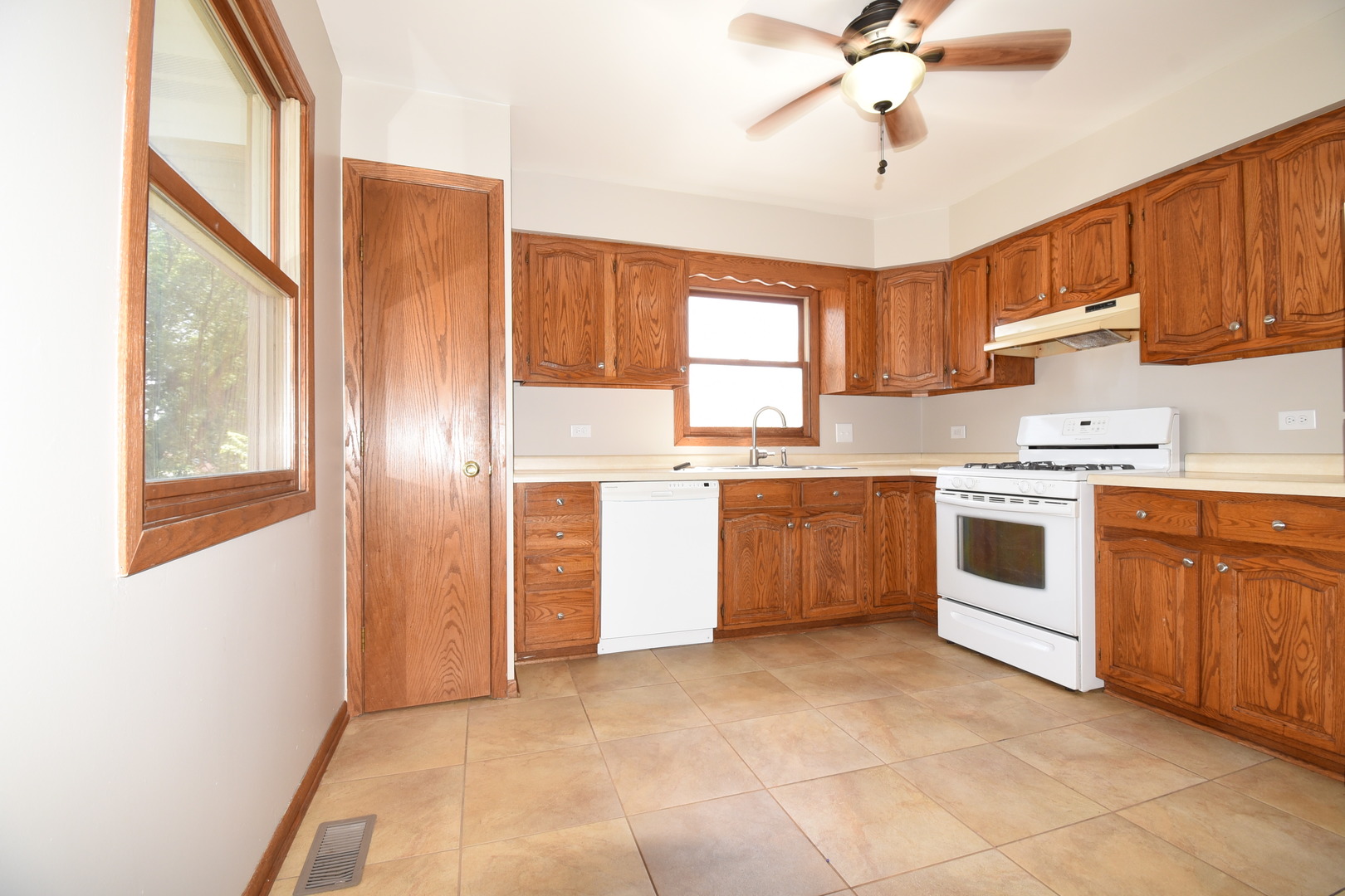 406 Garfield Road Fox Lake, IL 60041 - Photo 9 of 33 a kitchen with stainless steel appliances a stove a sink and white cabinets