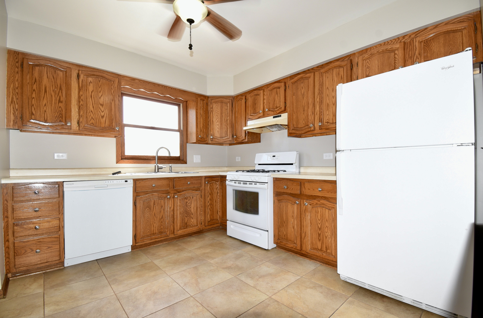 406 Garfield Road Fox Lake, IL 60041 - Photo 10 of 33 a kitchen with white cabinets and white appliances