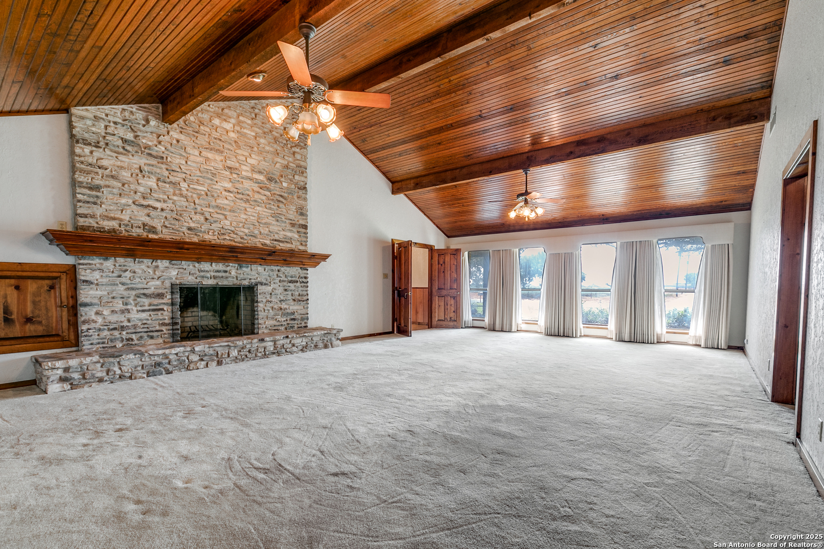 707 Berry Ranch Road Pearsall, TX 78061 - Photo 11 of 40 a view of an empty room with a fireplace