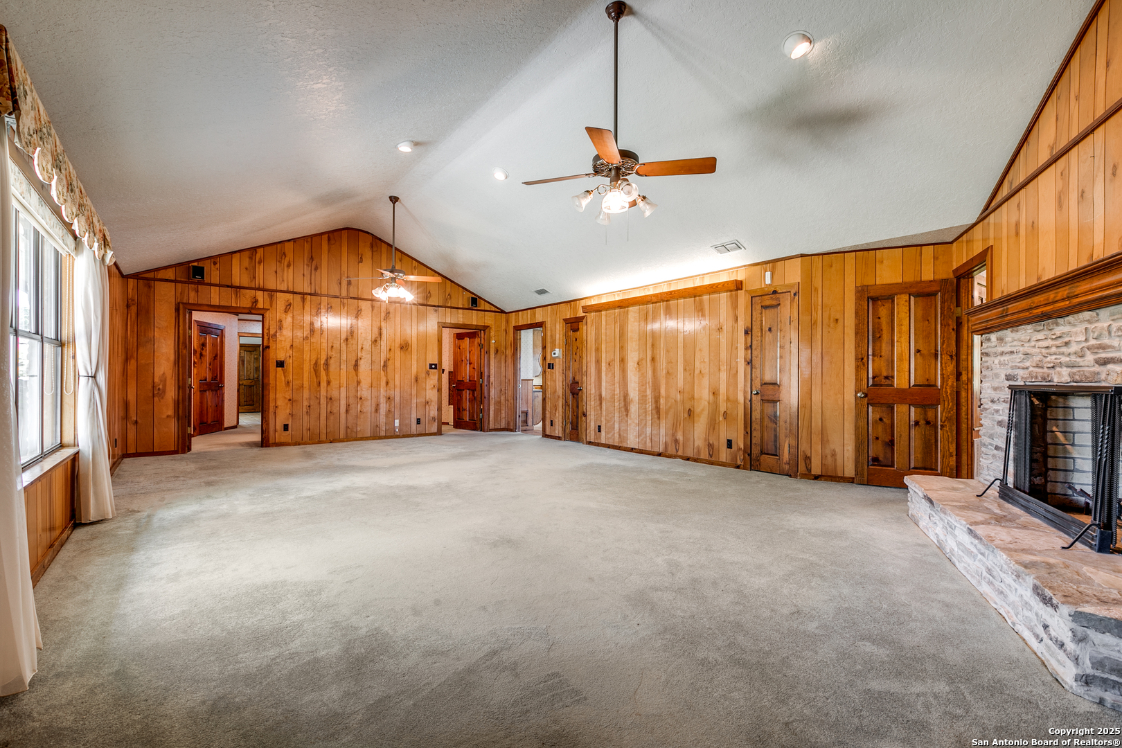707 Berry Ranch Road Pearsall, TX 78061 - Photo 13 of 40 a view of an empty room with a fireplace