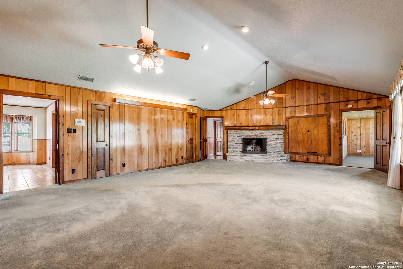 707 Berry Ranch Road Pearsall, TX 78061 - Photo 15 of 40 a view of a livingroom with furniture and a fireplace