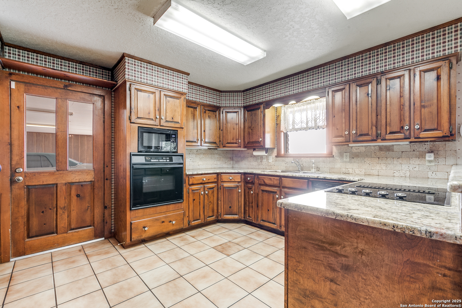 707 Berry Ranch Road Pearsall, TX 78061 - Photo 17 of 40 a kitchen with stainless steel appliances granite countertop a stove a sink and a microwave