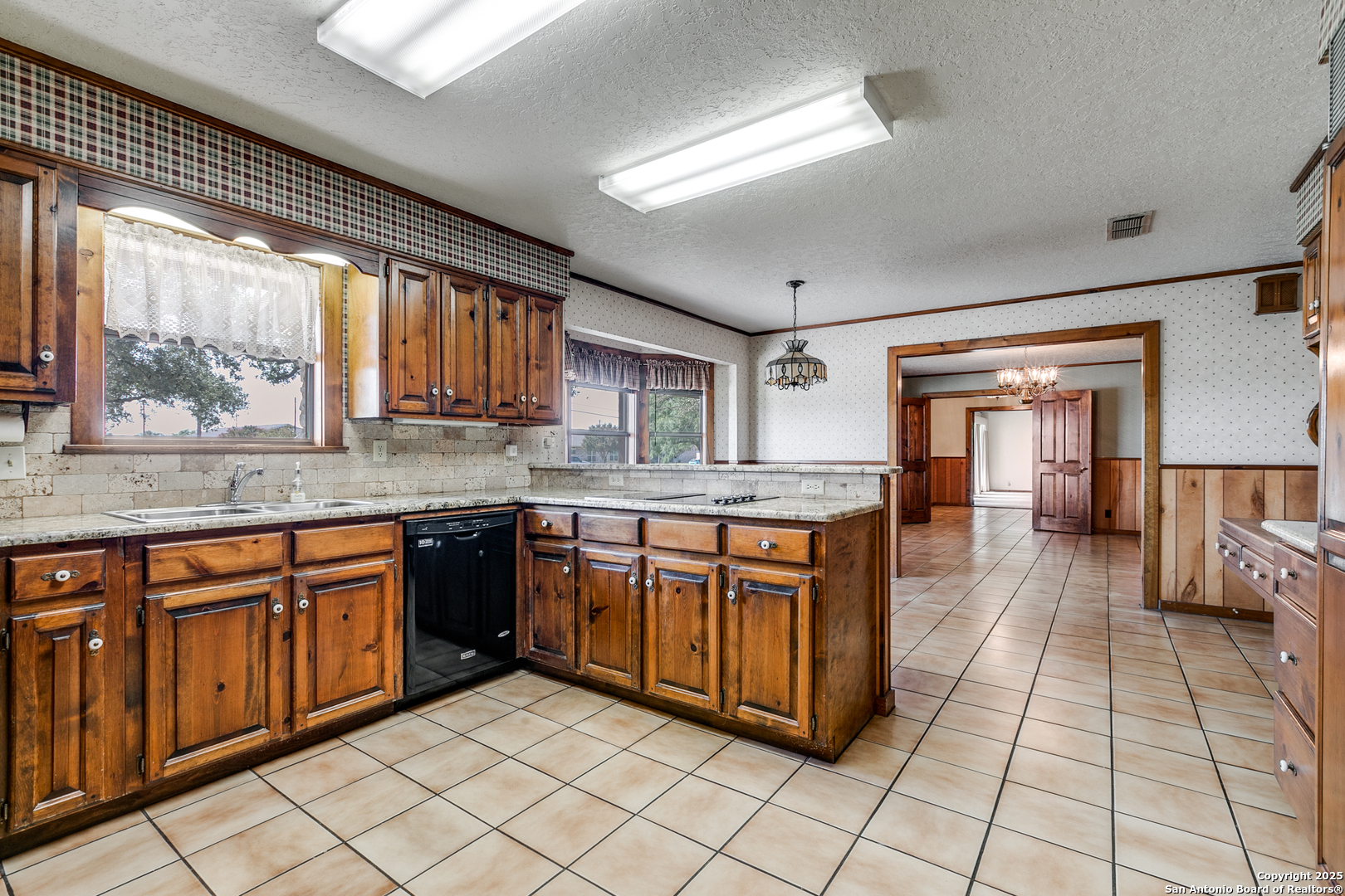 707 Berry Ranch Road Pearsall, TX 78061 - Photo 18 of 40 a large kitchen with stainless steel appliances granite countertop a sink and cabinets