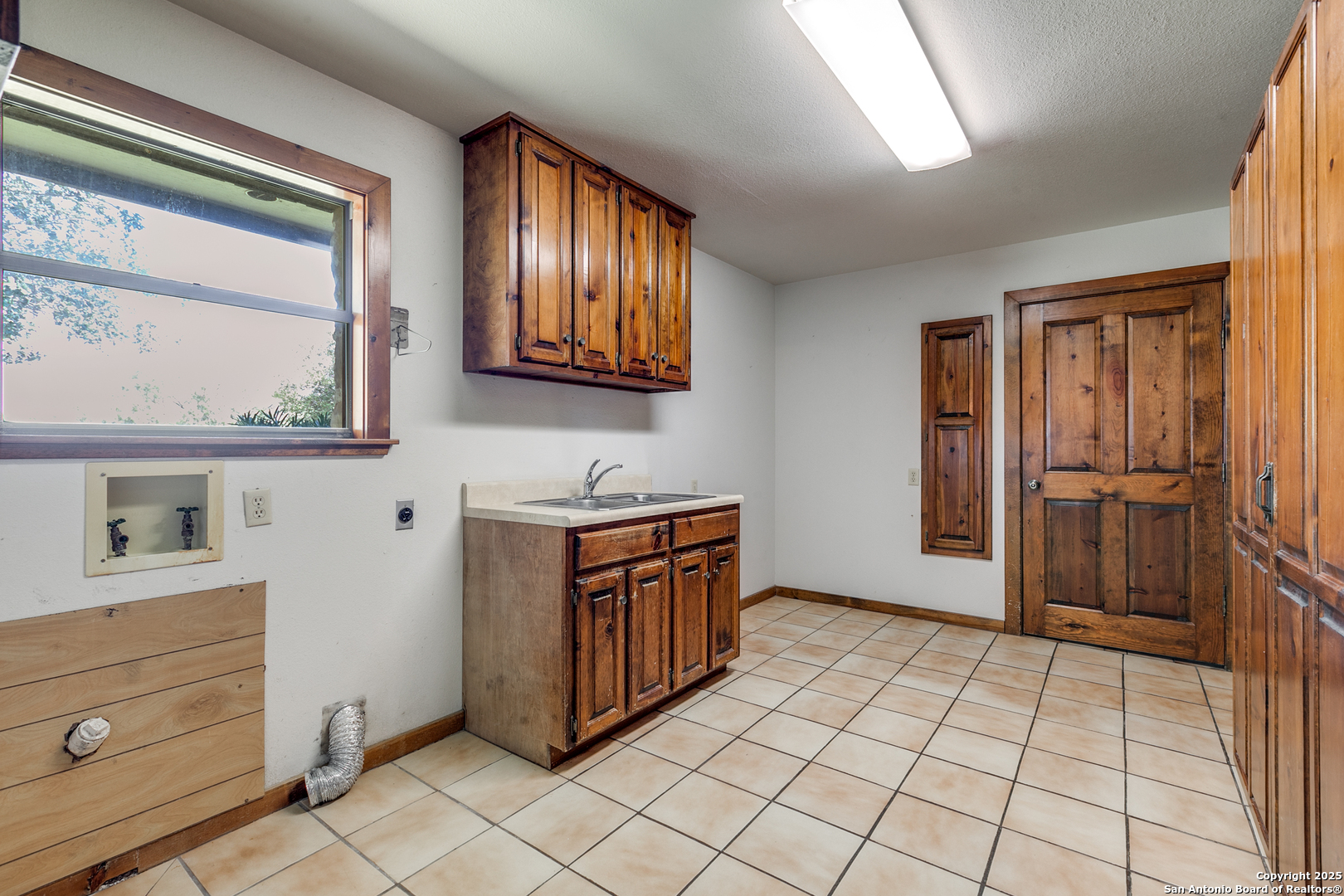 707 Berry Ranch Road Pearsall, TX 78061 - Photo 20 of 40 a view of a kitchen cabinets and a window