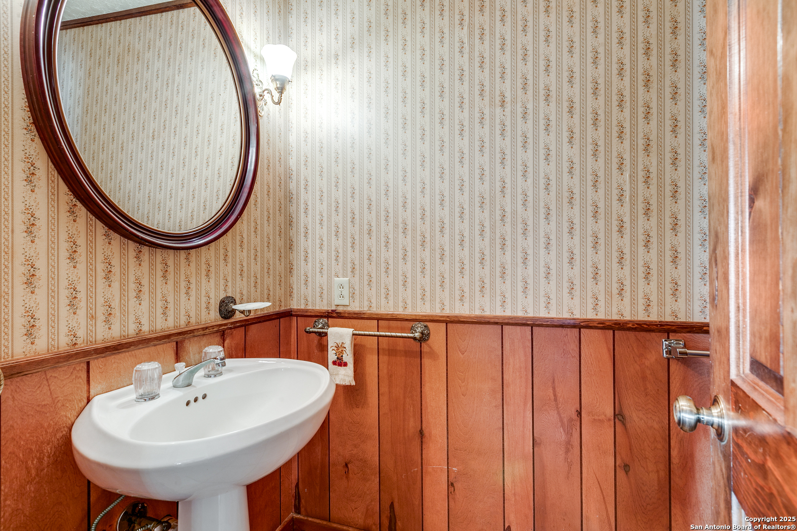 707 Berry Ranch Road Pearsall, TX 78061 - Photo 21 of 40 a bathroom with a sink a mirror and a shower curtain