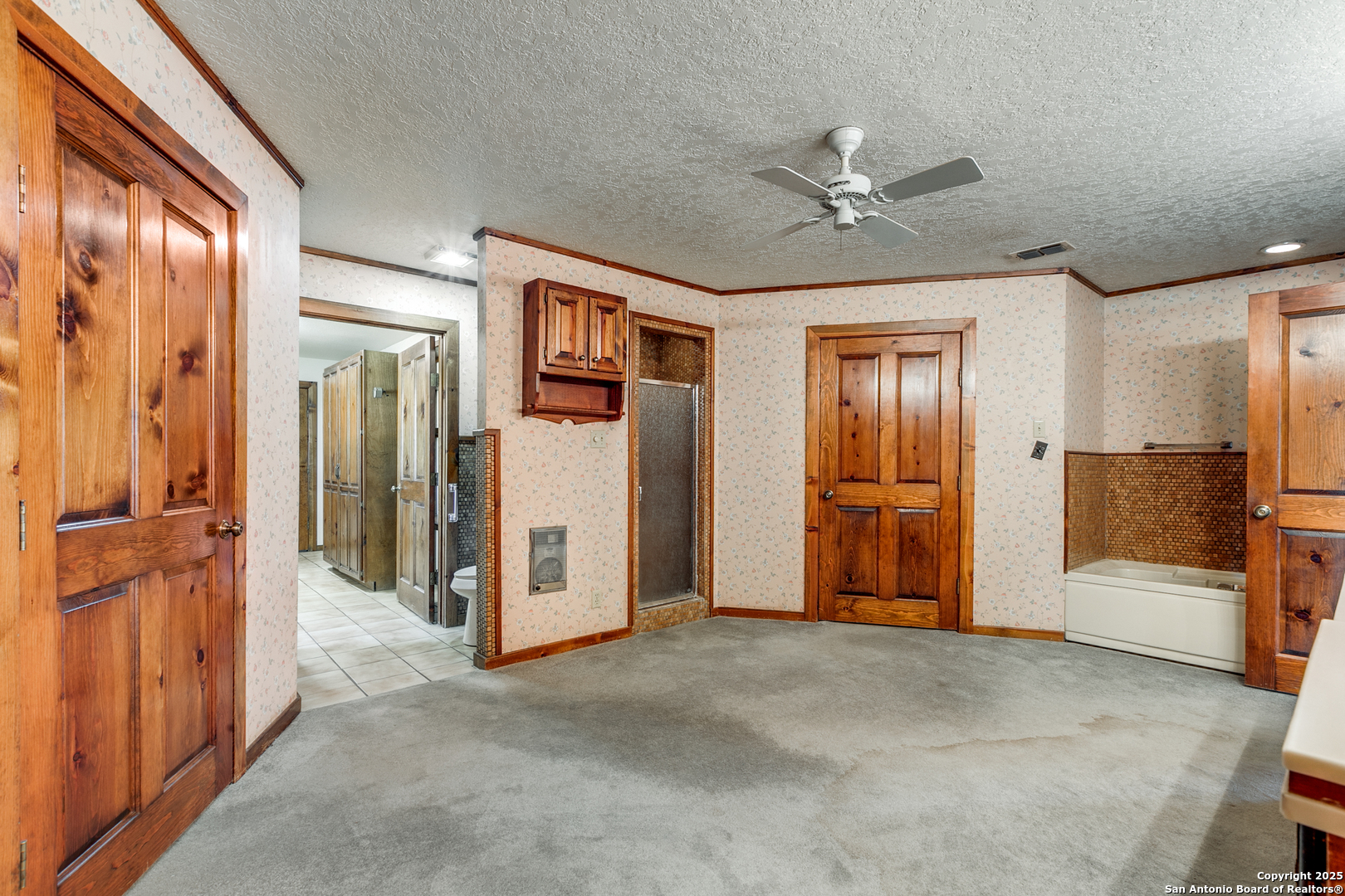 707 Berry Ranch Road Pearsall, TX 78061 - Photo 26 of 40 a view of a livingroom with a chandelier fan and closet area