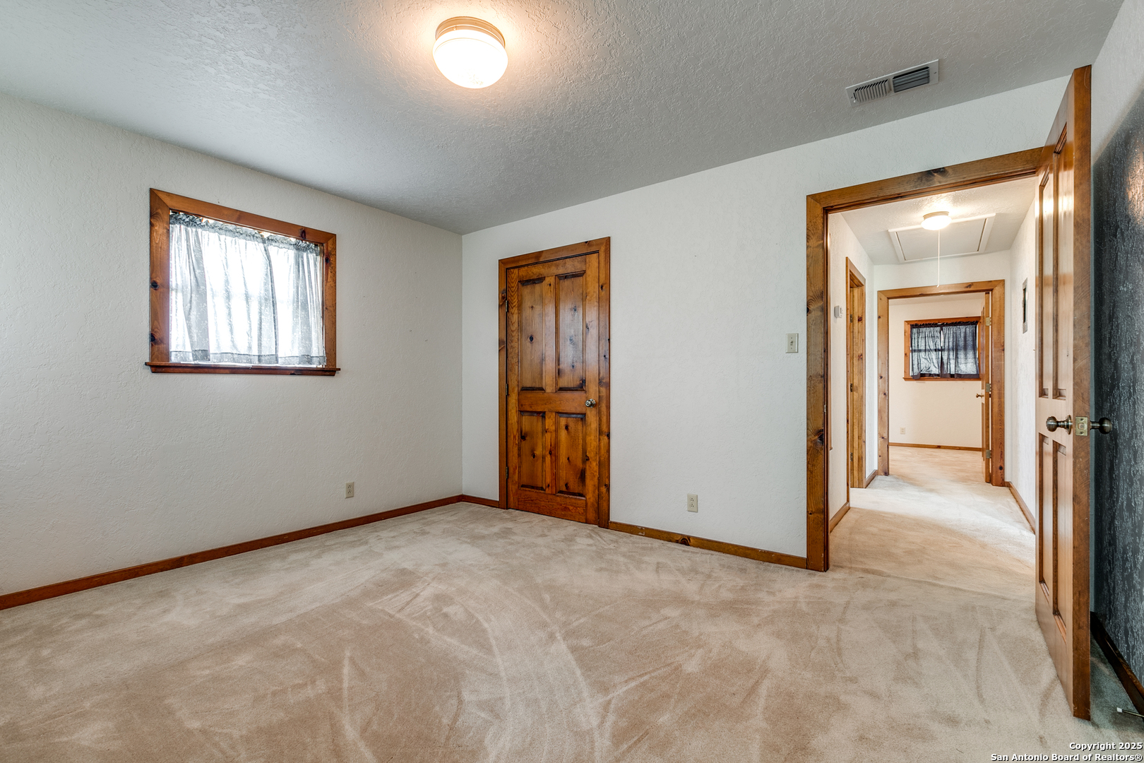 707 Berry Ranch Road Pearsall, TX 78061 - Photo 30 of 40 an empty room with windows and closet