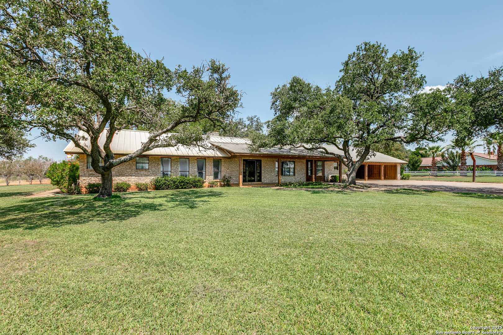707 Berry Ranch Road Pearsall, TX 78061 - Photo 3 of 40 a front view of a house with a garden
