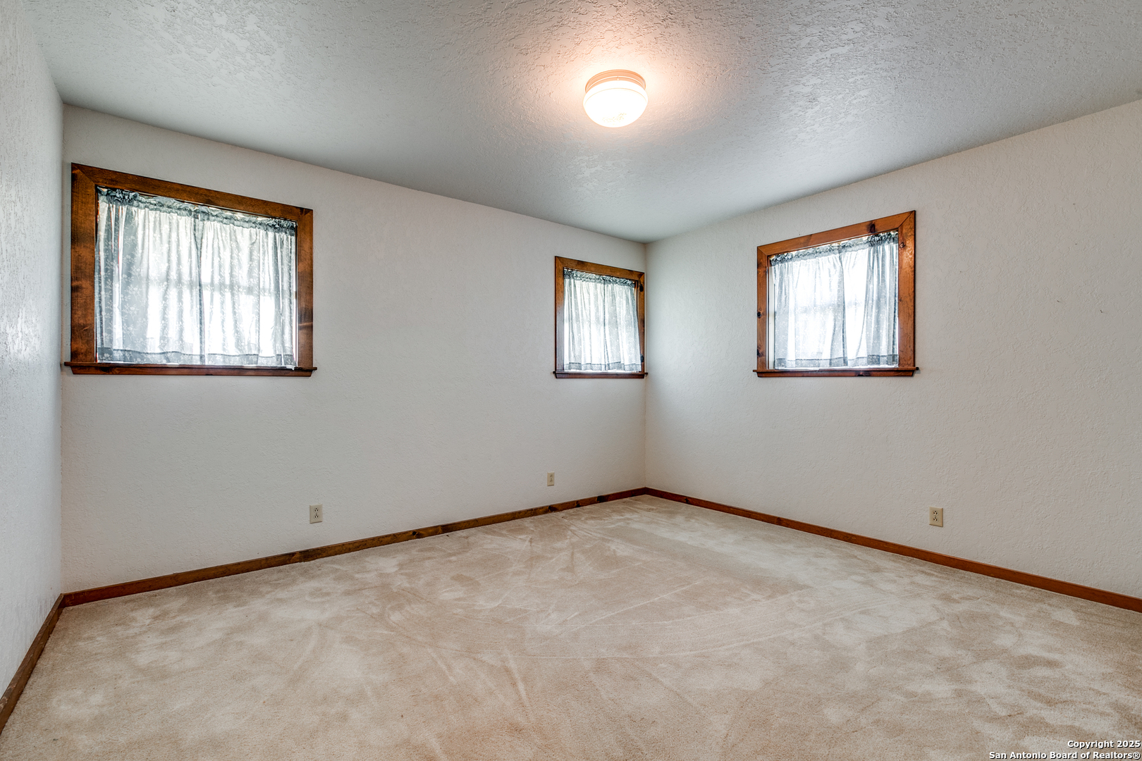 707 Berry Ranch Road Pearsall, TX 78061 - Photo 31 of 40 an empty room with windows
