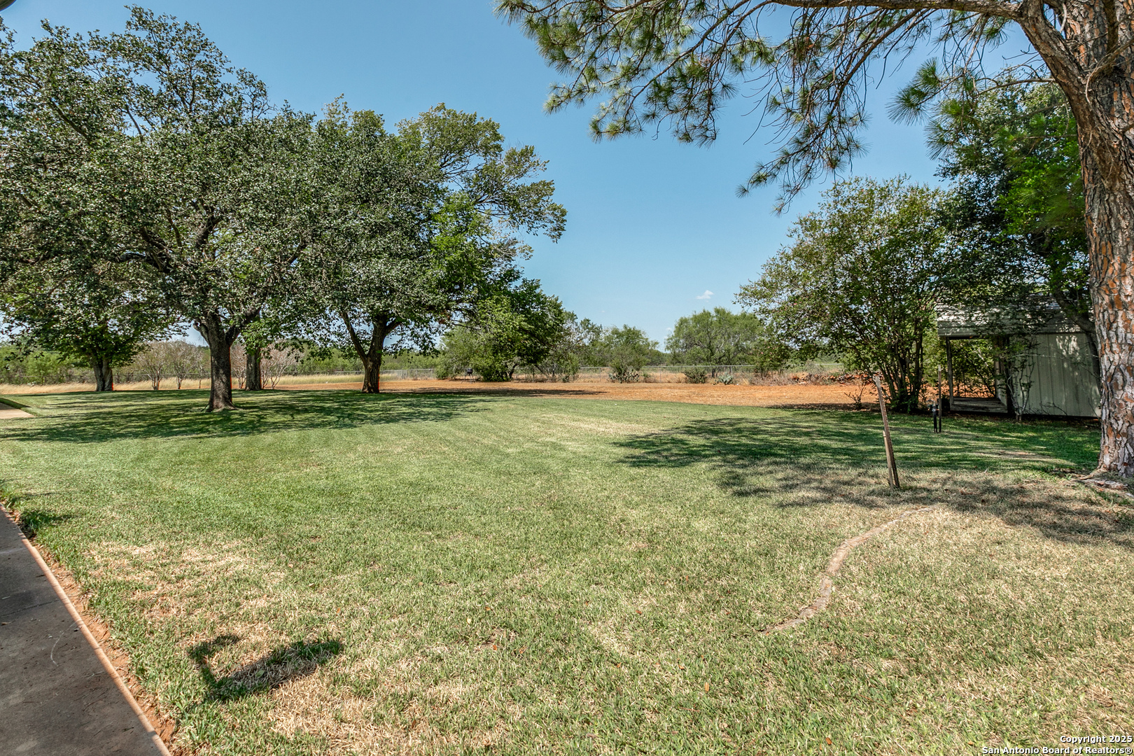 707 Berry Ranch Road Pearsall, TX 78061 - Photo 40 of 40 a view of outdoor space with green field and trees