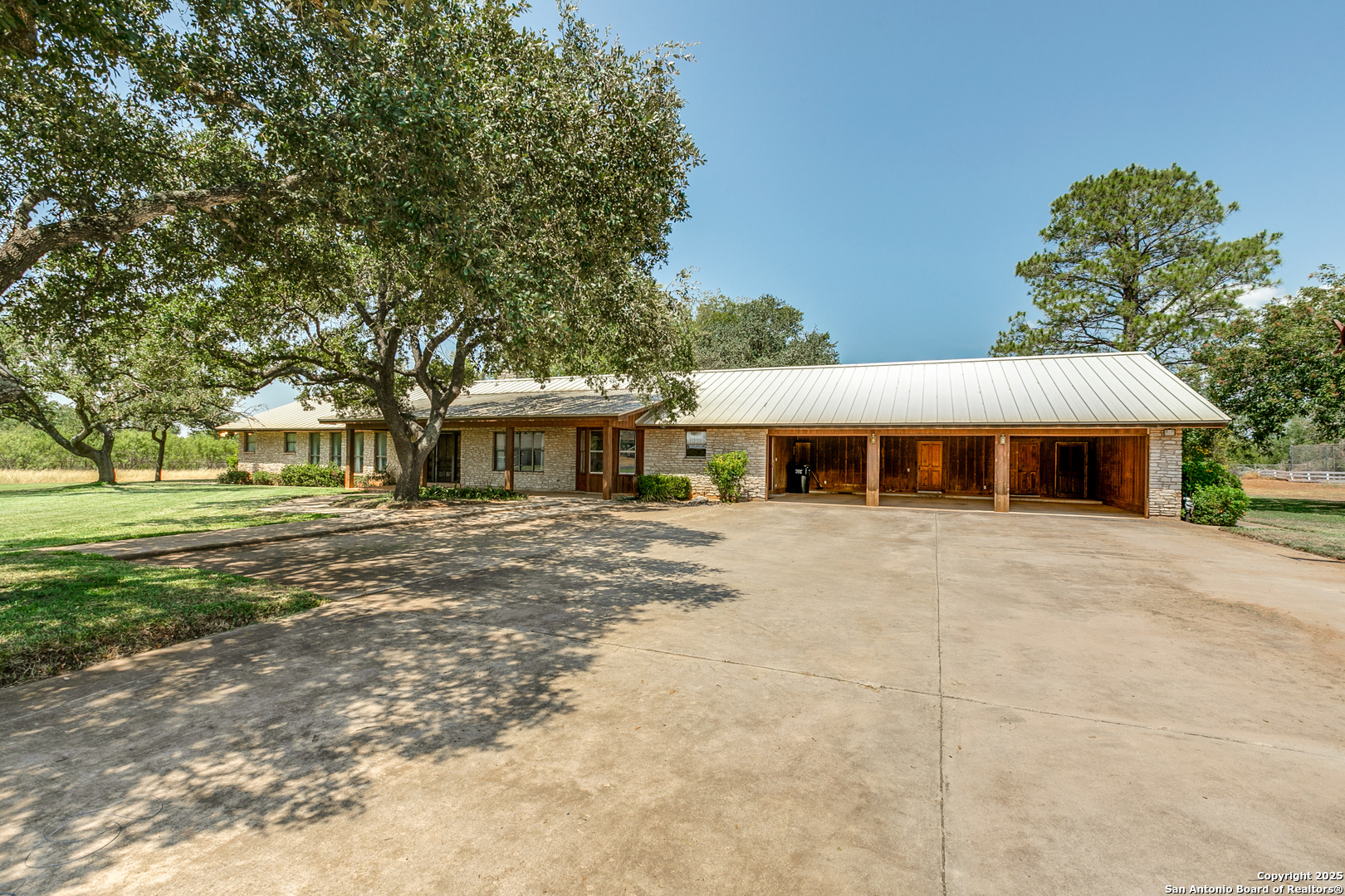 707 Berry Ranch Road Pearsall, TX 78061 - Photo 4 of 40 a front view of a house with a garden