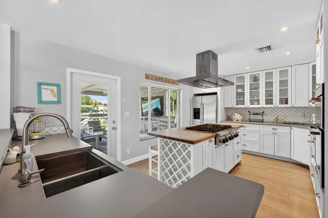 a bedroom with a bed and a flat screen tv on dresser