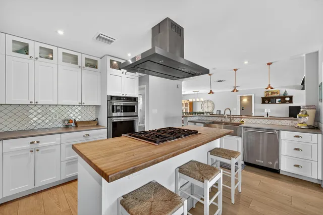 a bedroom with a bed and a flat tv screen on the table