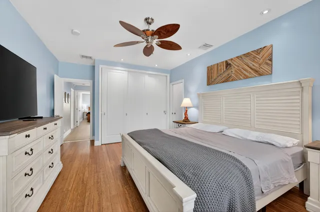 a spacious bedroom with a bed and a chandelier