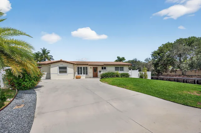 a front view of a house with a yard and a garage