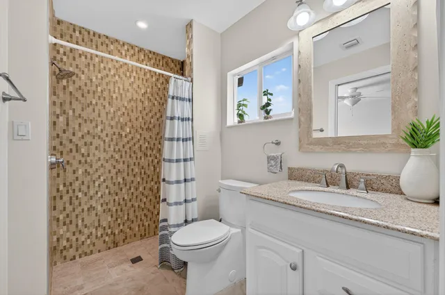 a living room with furniture a flat screen tv and a large window