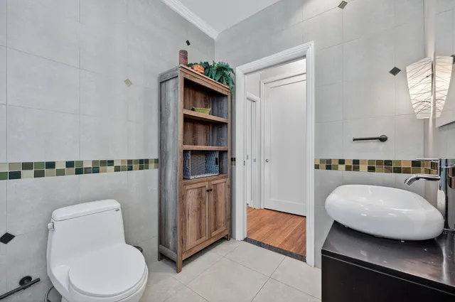 a view of a patio with table and chairs potted plants and palm tree
