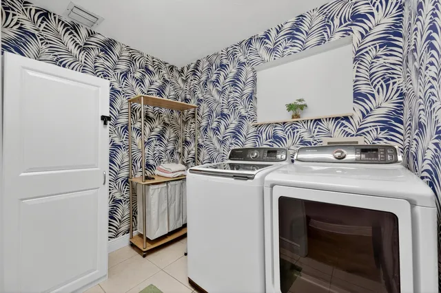 a view of a backyard with table and chairs and a barbeque